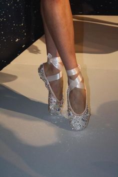 a close up of a person's shoes on a runway