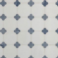 a white and blue tiled wall with small gray hearts on the tile, as well as a black cat