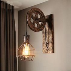 a light that is on the wall next to a window in a room with curtains