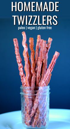 homemade twizzlers in a glass jar on a table with text overlay