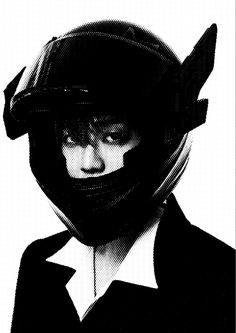 a black and white photo of a person wearing a helmet with horns on their head