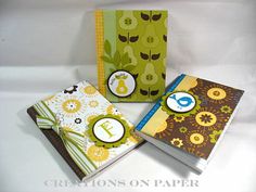 three small notebooks with different designs on them