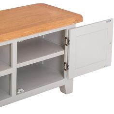 a white entertainment center with wooden top and shelves