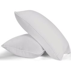 two white pillows sitting next to each other