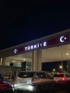 cars are parked in front of a building with a sign that says turkiye c