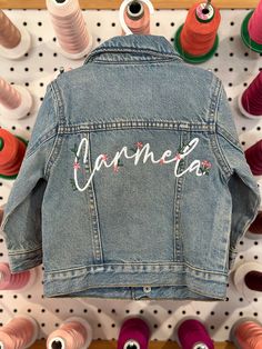 The perfect fall jacket for the babes! baby denim jacket professionally machine embroidered with polyester threads choose between two options: the floral name or the floral name with scattered flowers on front and back of jacket in the customization box: please write in the child's name as you would like it spelt (please proofread) ships free in the US Customizable Trendy Denim Jacket For Spring, Trendy Customizable Spring Denim Jacket, Customizable Denim Jacket For Spring, Spring Customizable Denim Jacket, Customizable Long Sleeve Denim Jacket For Spring, Customizable Denim Outerwear For Spring, Customizable Blue Denim Jacket For Spring, Customizable Spring Denim Jacket, Cute Fitted Embroidered Outerwear