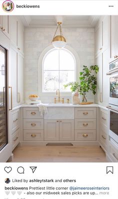 the instagram page on instagram shows an image of a kitchen with white cabinets and gold hardware