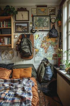 a bed sitting next to a window in a room with lots of pictures on the wall