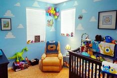 a baby's room decorated in blue and yellow