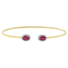 This 18KT Yellow Gold Flex Diamond and Ruby Bangle Bracelet is crafted with 1.69CT-TW of African rubies and 0.13CT-TW of diamonds, perfect for adding an exquisite touch of luxury to any look.