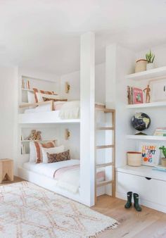 a bedroom with bunk beds and lots of shelves