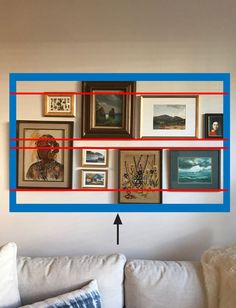 a living room with pictures on the wall and an arrow pointing to it's left