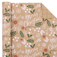 a brown wrapping paper with merry christmas lettering on it and holly leaves, snowflakes, and berries