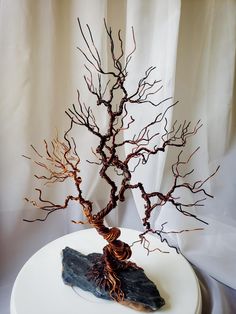 a tree sculpture sitting on top of a white table