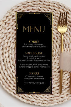 a plate with a fork, knife and napkin on it next to a black menu card