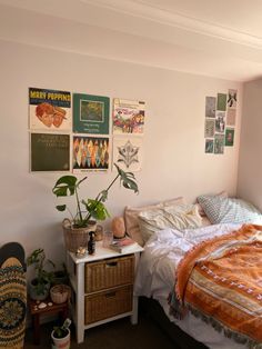 a bedroom with posters on the wall and a bed