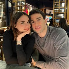 a man sitting next to a woman at a table