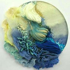 a glass plate with an image of a mermaid in blue and yellow colors on it