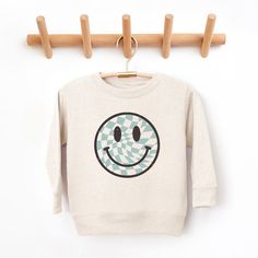 Looking for a cute sweatshirt for your kids? We have the perfect Checker Board Smiley Face graphic sweatshirt addition to their closet! Also available in youth sweatshirts. Playful Cartoon Print Sweatshirt For Playtime, Playful Cotton Hoodie With Graphic Print, Cute Letter Print Sweatshirt For Playtime, Cute Sweatshirt With Letter Print For Playtime, Playful Cotton Sweatshirt For Playtime, Playful Cotton Sweatshirt With Cartoon Print, Playful Cotton Crew Neck Sweatshirt, Playful Crew Neck Sweater With Graphic Print, Playful Long Sleeve Graphic Sweater