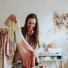 a woman is washing clothes in a pot