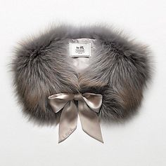 the fur collar is adorned with silver ribbon