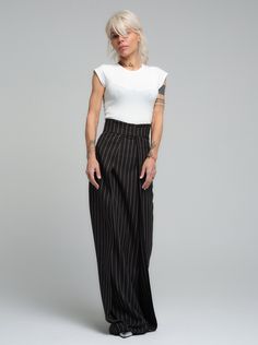 Subvert expectations in our unique maxi skirt. The high-waisted design defines your waist while the diagonal layered fabric elongates your body. FEATURES:A floor-length pinstripe maxi skirt. High-waisted design with a zipper at the back. Please note that this piece does not have pockets.100% Handmade. SIZE & FIT: Fit: A relaxed fit with room to moveModel is wearing size Small or S/M View our SIZE CHART before ordering MATERIALS & CARE: Content: Polyester Care: Machine wash on cold (30ºC) with a mild detergent. SHIPPING: Made to order, processing time is 15 working days This item will be shipped via DHL Chic High Waist Vertical Stripes Wide Leg Pants, Chic High Waist Wide Leg Pants With Vertical Stripes, Formal Spring Maxi Bottoms, Spring Formal Maxi Bottoms, Formal Maxi Bottoms For Spring, Chic High Waist Pinstripe Wide Leg Pants, Chic Striped Lined Maxi Skirt, Chic Striped Lined Skirt Bottoms, Formal Summer Maxi Bottoms