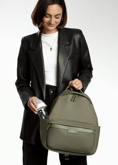 Crafted from our high-quality nylon and designed with ample storage space, the Eli backpack boasts a modern, minimalist design that complements various styles. A dedicated compartment for a 13" laptop, multiple pockets, and organizational features make it ideal for both work and play. Whether you're heading to the office, school, or a weekend adventure with your littles, Eli is the perfect companion. Common Uses: Diaper Bag, Work Bag, Travel Bag Modern Nylon Laptop Bag For School, Modern Everyday Nylon Laptop Bag, Functional Workwear Backpack, Trendy Nylon Backpack For Commuting, Modern Nylon Backpack, Versatile Nylon Backpack For Business, Versatile Business Backpack In Nylon, Modern Workwear Backpack With Zipper Closure, Modern Business Backpack With Functional Pockets