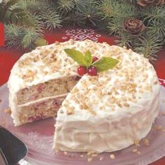 there is a cake with white frosting and berries on it