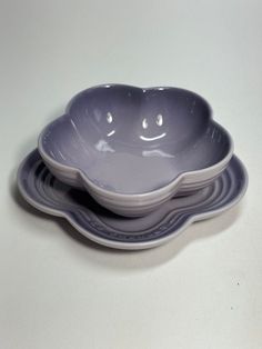 three bowls with faces on them sitting next to each other in front of a white background