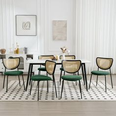 a dining room table with four chairs and a rug on the floor in front of it