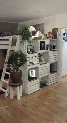 a room with a ladder and some shelves filled with items on top of each shelf