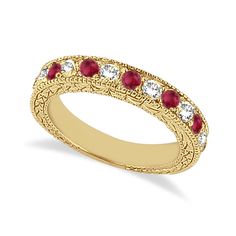 a yellow gold ring with red and white stones