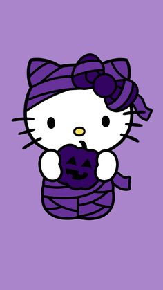 hello kitty holding a jack - o'- lantern in her hand on a purple background