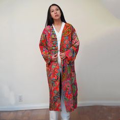 This is a washable printed batik robe/ kimono handmade by artisans, thick duster and home jacket. Because of the upcycled material and handmade nature of this item, each batik quilt kimono is not alike. The print will be of slightly different pattern and color but in variation of black, blue, pink, purple, green mix pattern. This thick quilted patchwork robe is handmade by artisans in Java using upcycled printed fabric from leftover fabric sourced from clothing manufacturer. This jacket is NOT r Bohemian Block Print Kimono For Spring, Long Bohemian Block Print Kimono, Fall Patchwork Long Kimono, Multicolor Kimono With Block Print, Bohemian Outerwear With Floral Print And Kimono Sleeves, Handmade Multicolor Spring Kimono, Spring Batik Print Long Sleeve Kimono, Oversized Bohemian Outerwear With Floral Print, Bohemian Long Printed Outerwear