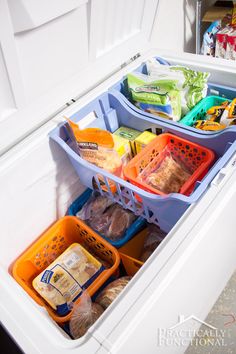 an organized refrigerator with freezer organization bins and food in the bottom drawer, labeled chest freezer organization