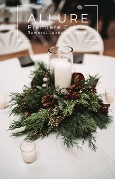 the centerpiece is decorated with pine cones, berries and evergreens as well as candles