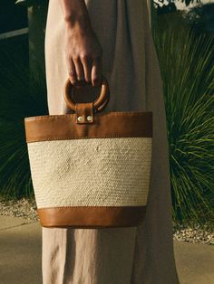 Meet the bag of the season, handmade in Peru by local artisans in a woman-owned factory. We added an effortless ring handle and an easy zip closure so you can keep your stuff safe (you're welcome). (This one comes in Desert Brown/Natural.) * All pieces are subject to slight differences in shape, size, and color, which are natural (and part of the charm) of a handmade product. Measurements:- Top Opening = 11 1/2"- Bag Height = 9"- Base Width = 5"- Base Length = 8" | Bonnie Bag in Desert Brown Nat Ring Handle, Basket Bag, Local Artisans, Peru, Ring, Color