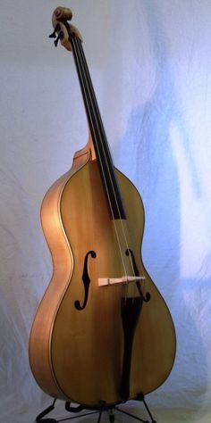 an instrument sitting on top of a stand against a white background with the strings still attached to it