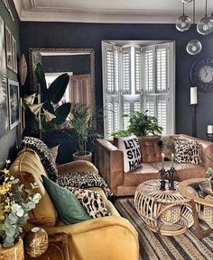 a living room filled with lots of furniture next to a window covered in plants and pictures