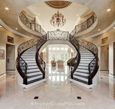 a large foyer with stairs and chandelier