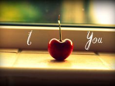 an apple sitting on top of a window sill next to the words i love you