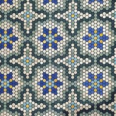 an abstract mosaic pattern with blue, yellow and white dots on the center is shown