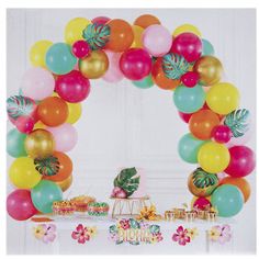 a bunch of balloons that are in the shape of a arch with flowers and leaves on it