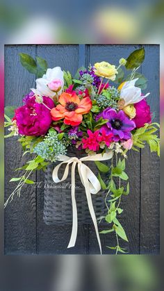 a basket filled with lots of colorful flowers