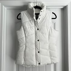 Brand New, Without Tags. Never Worn. Still Has Protective Cover Wrapped Around Zipper Pull. New York & Company White Puffer Vest. Zipper Closure With Snaps. Size Small. White Puffer Vest, Puffer Vest, Puffer, Zipper, Jackets & Coats, Jackets For Women, New York, Brand New, White