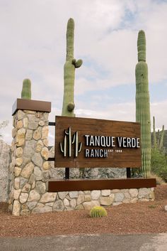 the sign for tanque verdde ranch is in front of some cacti