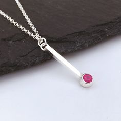 This elegant, minimal design, vertical bar ruby necklace is perfect as a Christmas, birthday or anniversary gift. Ruby is the July birthstone and also represents a 40th anniversary.  Made by hand from sterling silver, the vertical bar is 2mm wide and 20mm long and has a round 5mm diameter tube setting at the bottom.  This is set with a beautiful, raspberry coloured, 4mm lab created faceted ruby.  Lab created rubies are exactly the same composition as mined rubies - this is not a cubic zirconia o Red Minimalist Birthstone Necklace, Minimalist Red Birthstone Necklace, 40th Anniversary Gifts, Necklace Ruby, Vertical Bar Necklace, Vertical Bar, Ruby Necklace, 40th Birthday Gifts, Ruby Jewelry