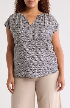 An eye-catching pattern covers this fabulous popover top designed with a notched neckline. 30" length V-neck Cap sleeves 80% rayon, 20% nylon Hand wash, line dry Imported Patterned V-neck Rayon Tops, Patterned Rayon V-neck Top, Patterned V-neck Blouse For Work, Patterned V-neck Workwear Blouse, Casual V-neck Tops With Geometric Pattern, Chic Viscose Tops With Split Neck, Chic Viscose Top With Split Neck, Patterned Printed Viscose Top, Printed V-neck Viscose Blouse