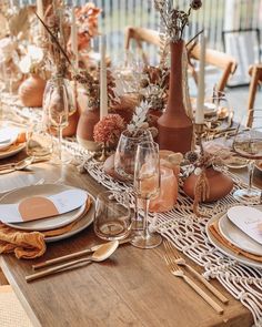 the table is set with plates and place settings