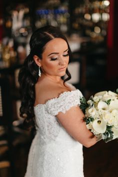 a woman in a wedding dress holding a bouquet